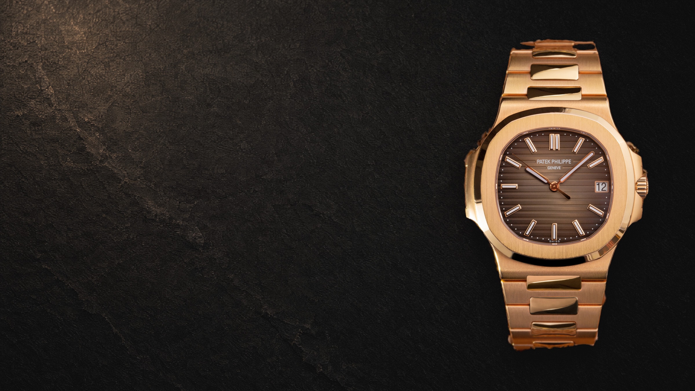 Patek Philippe Nautilus in rose gold, seen from above on black stone